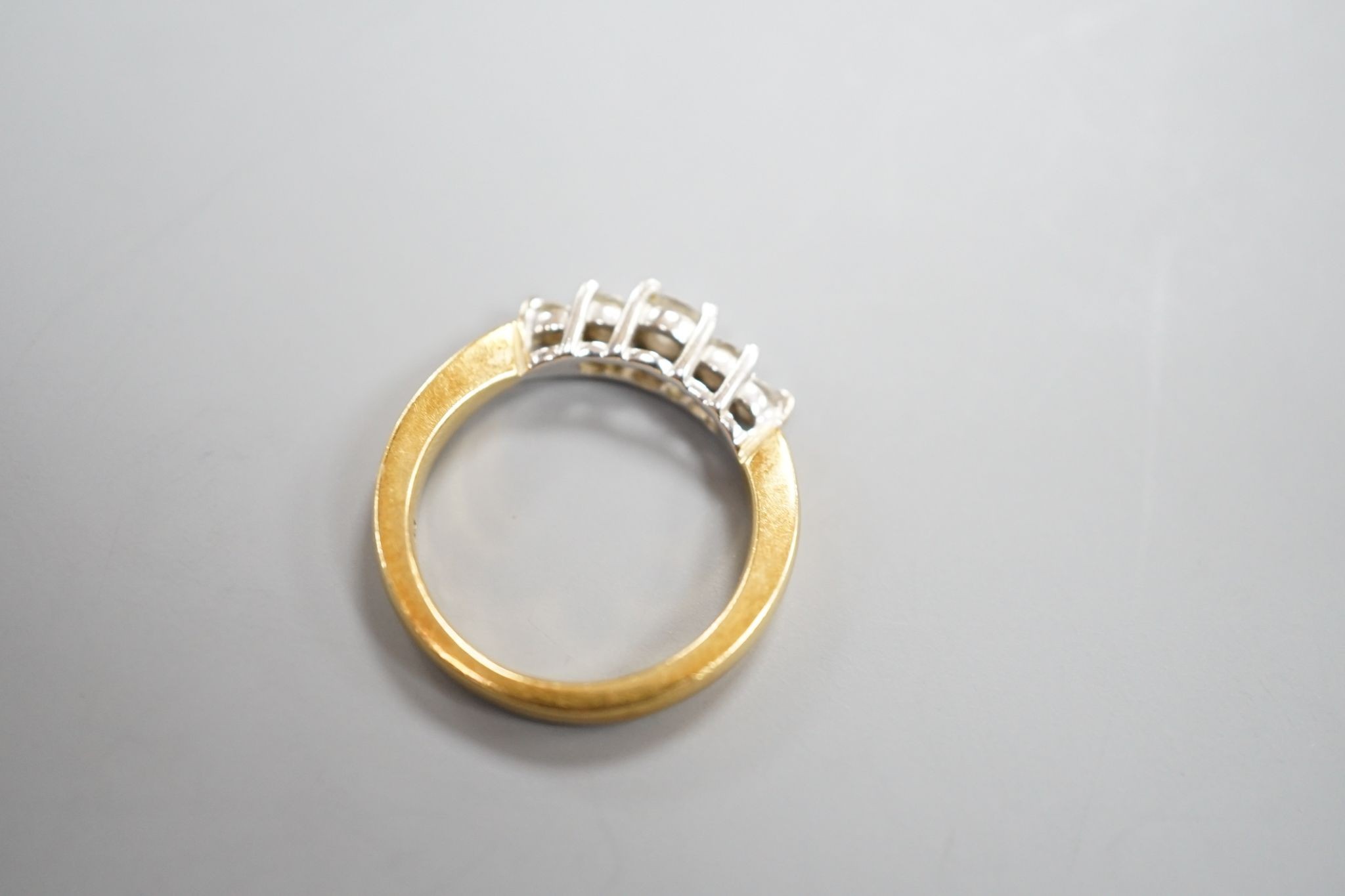 A modern 18k yellow metal and graduated five stone diamond set half hoop ring, size N, gross weight 5.4 grams.